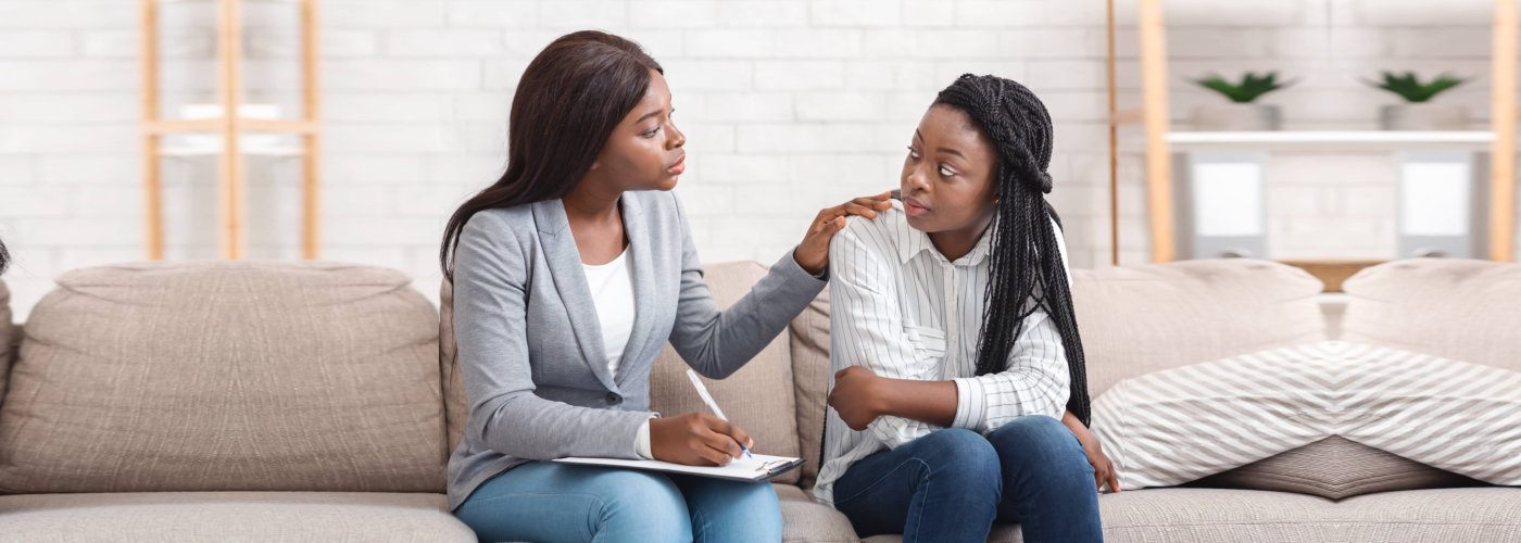 therapist comforting her patient